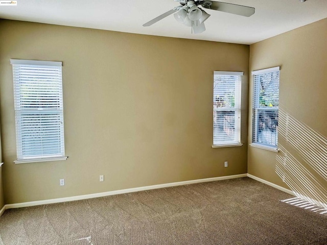 unfurnished room with ceiling fan and carpet