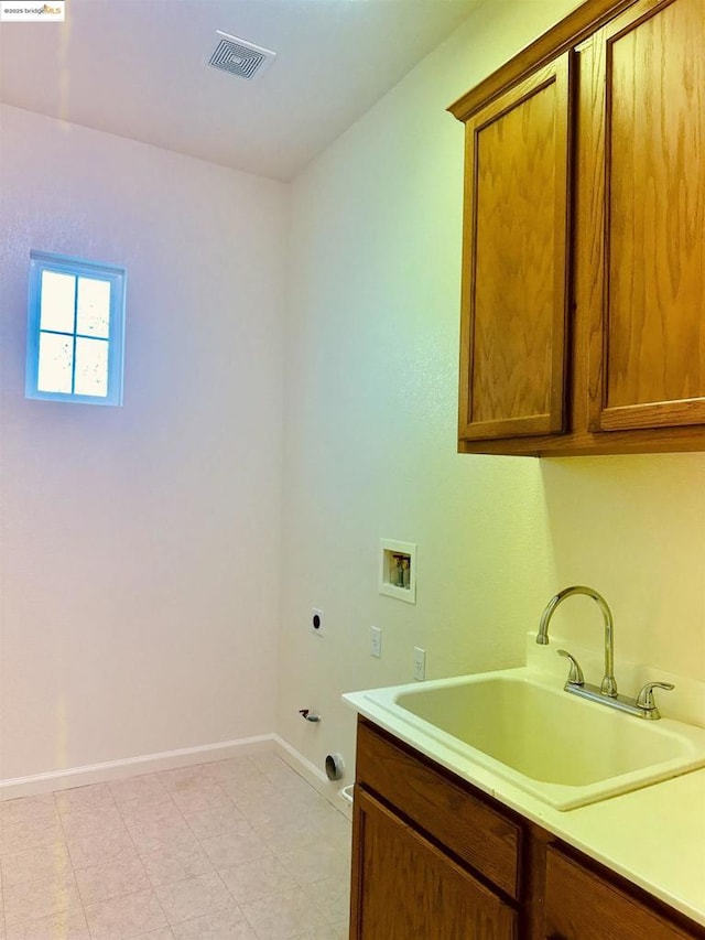 clothes washing area with sink, cabinets, hookup for a gas dryer, washer hookup, and hookup for an electric dryer