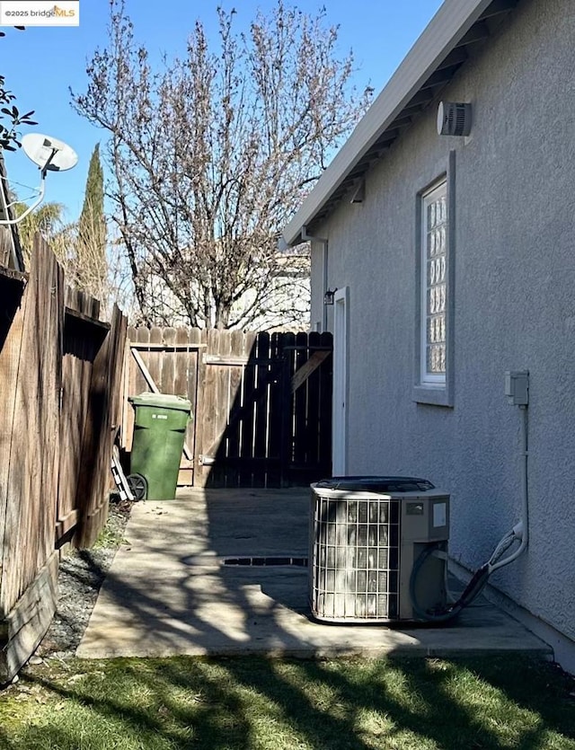 view of side of property featuring a patio and central air condition unit