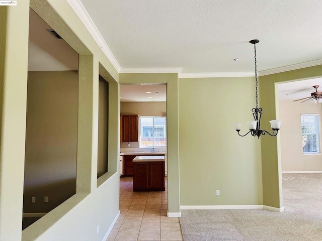 interior space with crown molding, light tile patterned flooring, and a chandelier