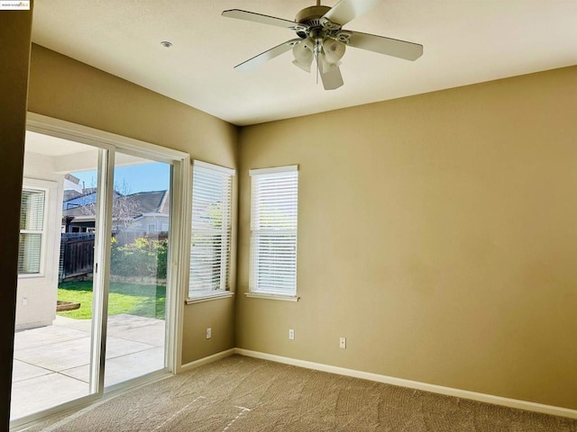 carpeted empty room featuring ceiling fan