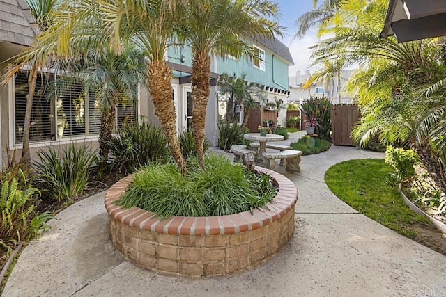 view of property's community with a patio area and fence