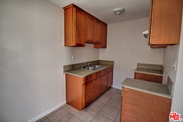 kitchen featuring sink and light tile patterned flooring