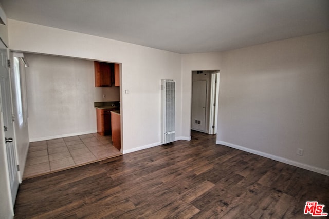 unfurnished room with dark hardwood / wood-style floors