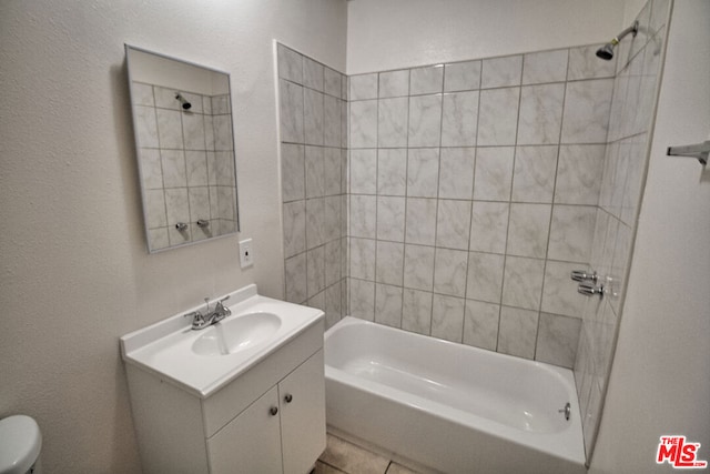 full bathroom featuring vanity, toilet, and tiled shower / bath