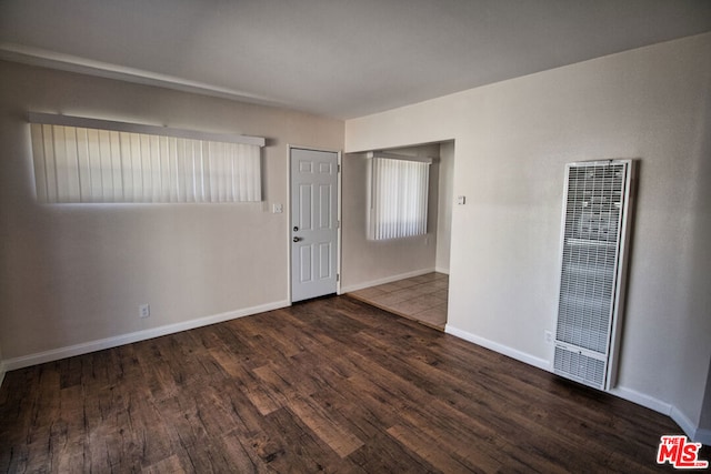 empty room with dark hardwood / wood-style flooring