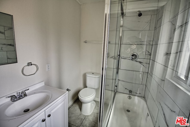 full bathroom featuring vanity, tile patterned floors, shower / bath combination with glass door, and toilet