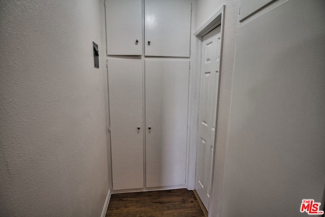 corridor with dark wood-type flooring