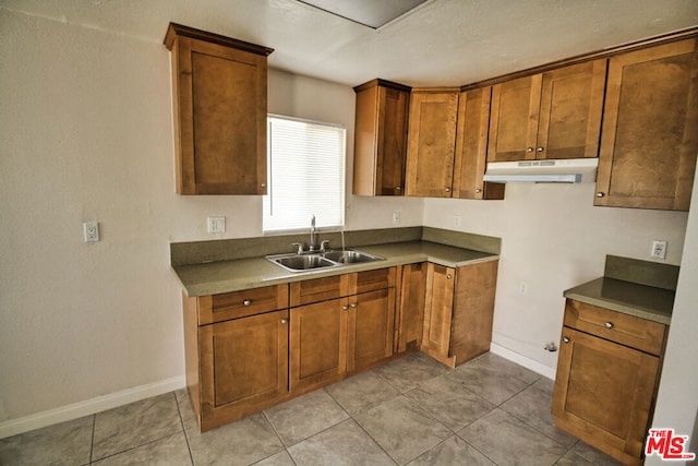 kitchen with sink and light tile patterned floors