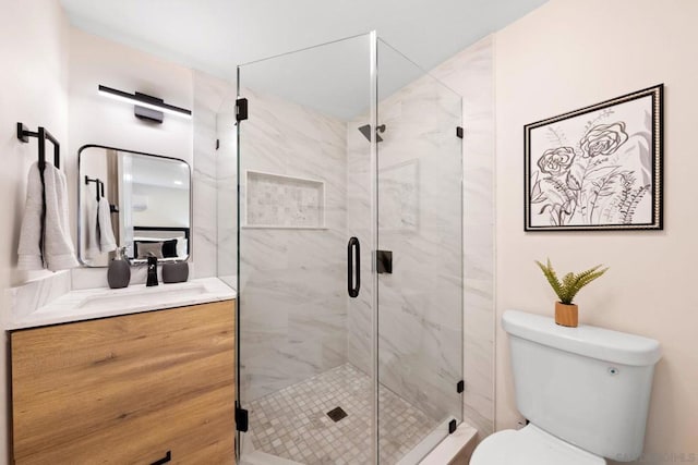 bathroom featuring walk in shower, vanity, and toilet