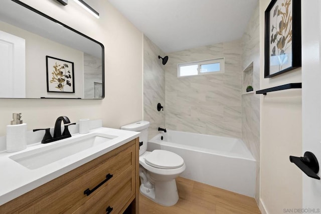 full bathroom featuring vanity, toilet, tiled shower / bath combo, and wood-type flooring