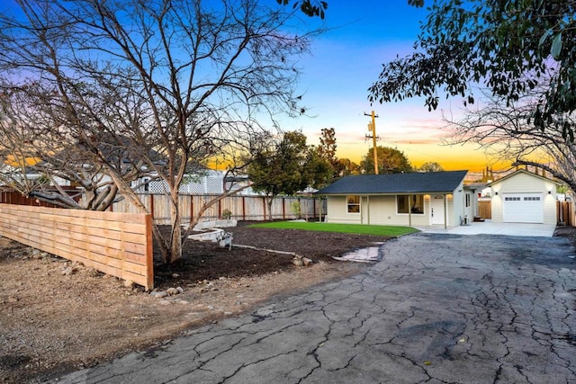 ranch-style house with a garage and an outdoor structure