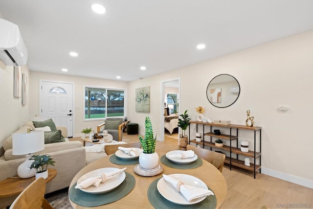 dining space with light hardwood / wood-style flooring and an AC wall unit