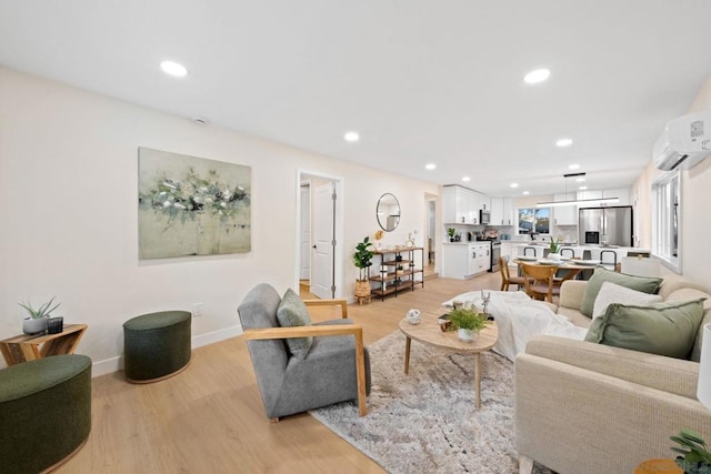 living room featuring a wall mounted AC and light hardwood / wood-style floors