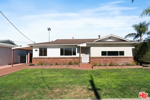 ranch-style house featuring a carport and a front yard