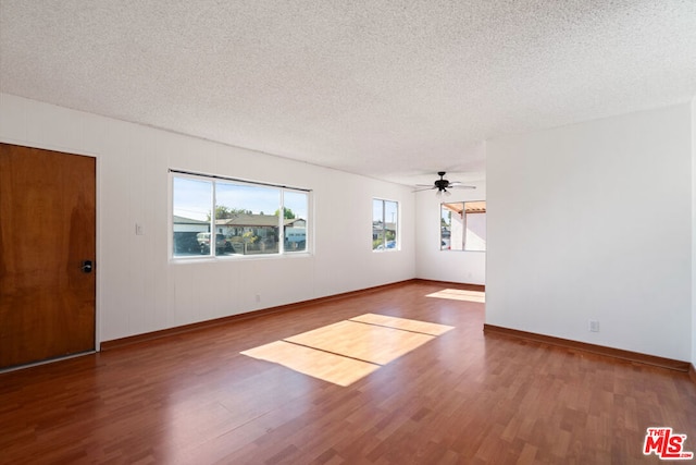 spare room with ceiling fan, hardwood / wood-style floors, and a textured ceiling