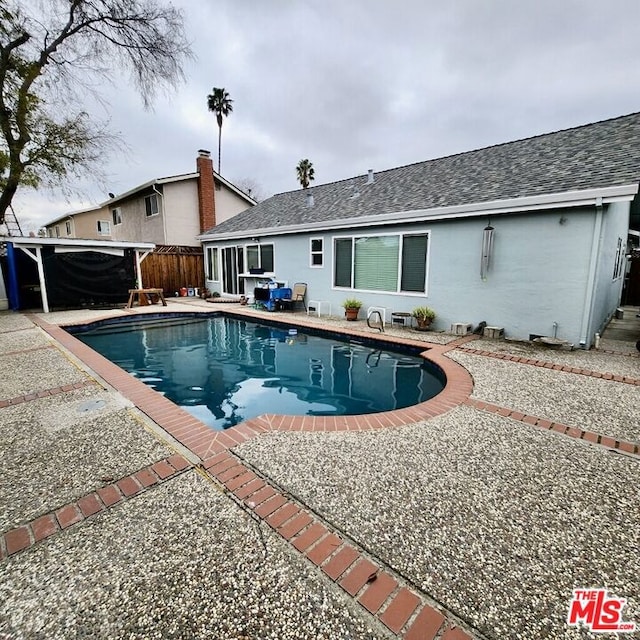 view of swimming pool with a patio area