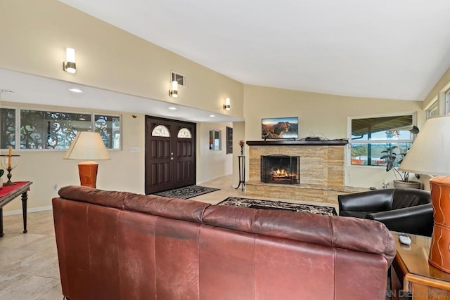 living room featuring light tile patterned floors and vaulted ceiling