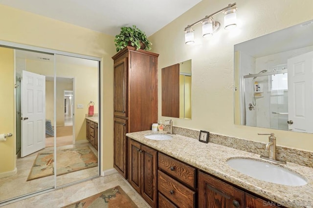 bathroom with vanity and a shower with door