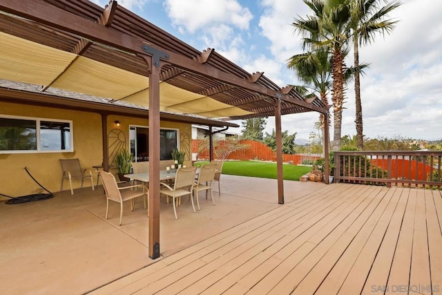 wooden terrace with a yard and a pergola