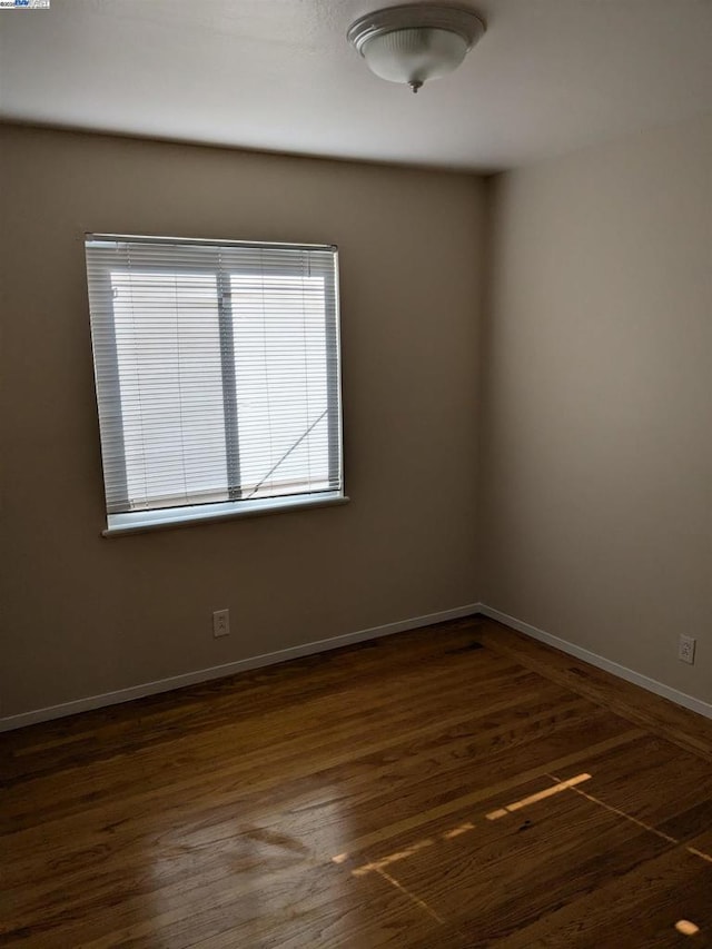 unfurnished room featuring dark hardwood / wood-style floors