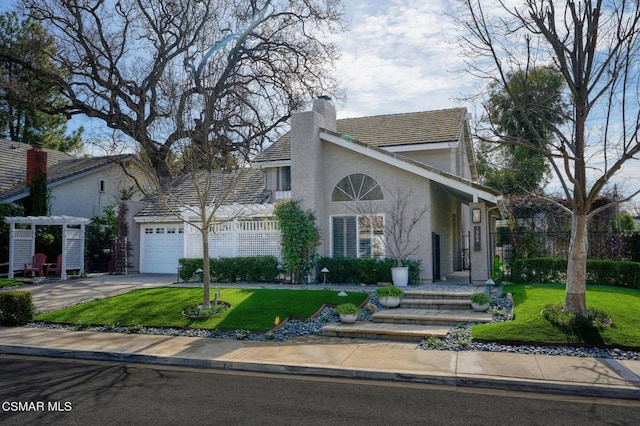 view of front of property with a garage and a front lawn