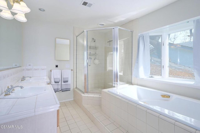 bathroom with tile patterned flooring, vanity, and an enclosed shower