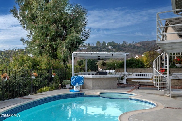 view of swimming pool featuring a pergola, a patio, and an in ground hot tub