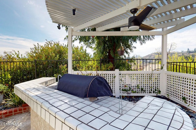 view of patio featuring ceiling fan