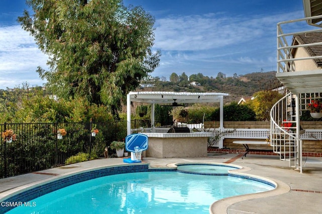 view of pool with a pergola, a patio, ceiling fan, and an in ground hot tub