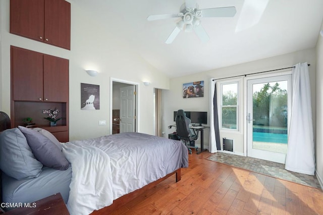 bedroom with light hardwood / wood-style flooring, access to outside, ceiling fan, and vaulted ceiling