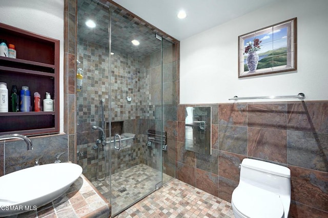 bathroom with toilet, tile walls, and walk in shower