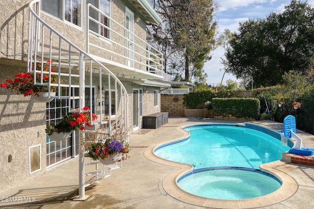 view of pool featuring an in ground hot tub and a patio