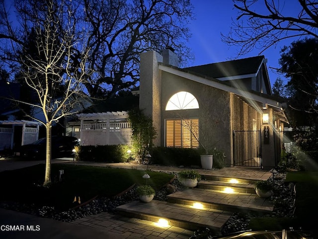 view of property exterior at night