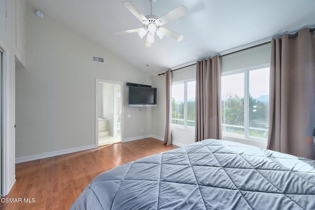 bedroom featuring wood-type flooring, high vaulted ceiling, ceiling fan, and ensuite bathroom