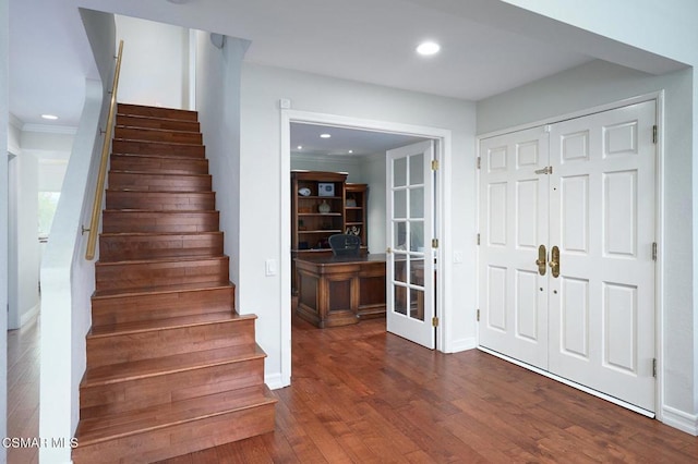 staircase featuring hardwood / wood-style flooring and ornamental molding