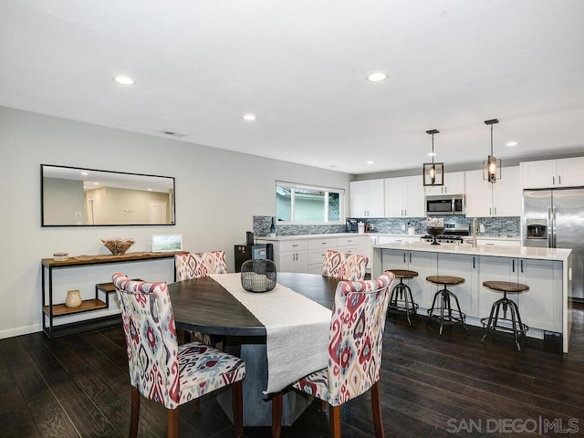 dining space featuring dark hardwood / wood-style floors