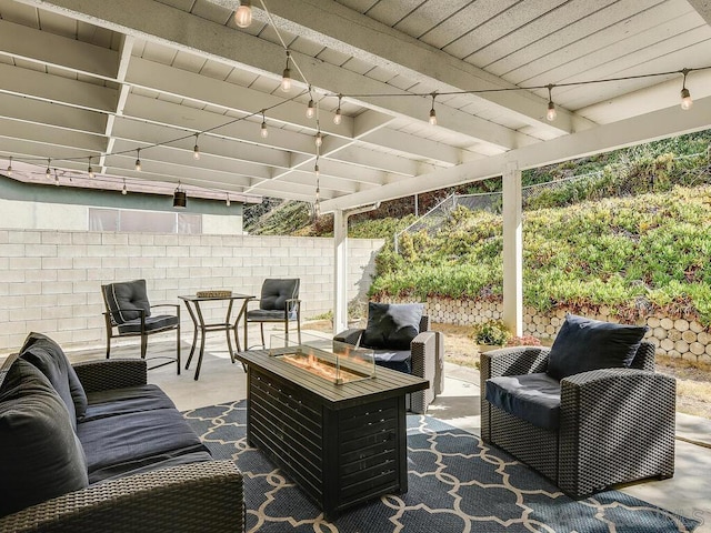 view of patio / terrace with an outdoor living space with a fire pit