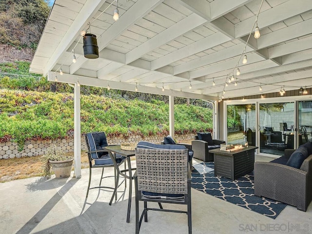 view of patio / terrace featuring an outdoor living space with a fire pit