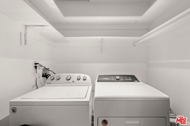 clothes washing area with washer and clothes dryer