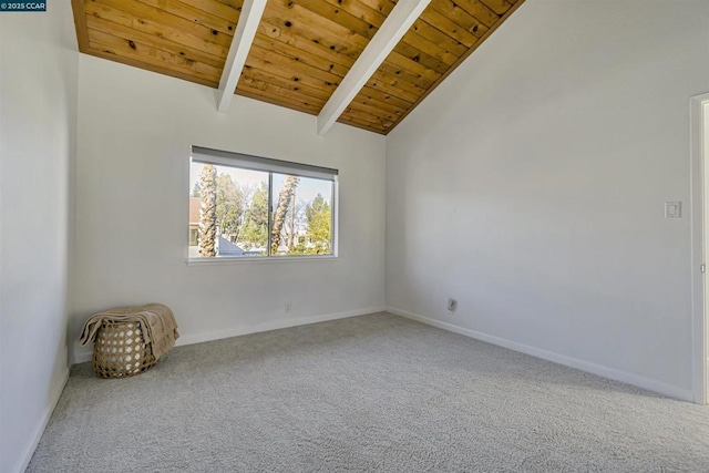 carpeted spare room with lofted ceiling with beams and wood ceiling