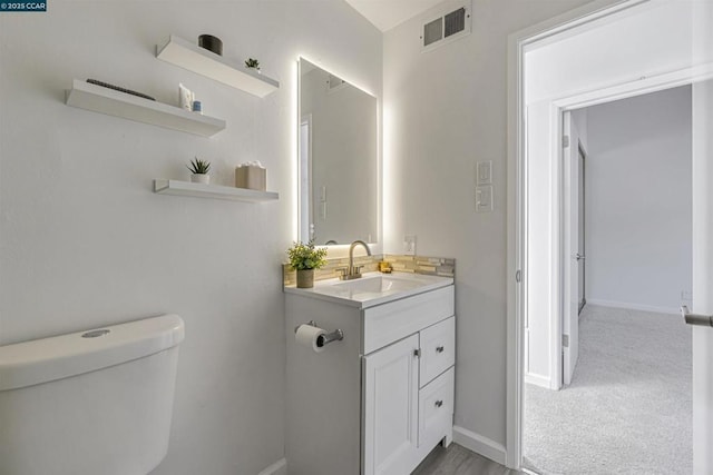 bathroom with vanity and toilet