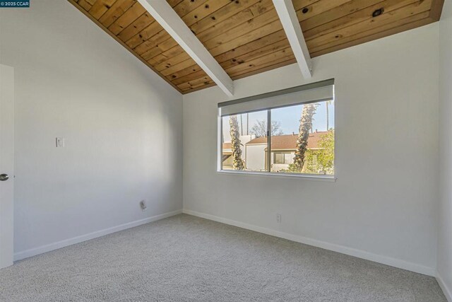 unfurnished room featuring lofted ceiling with beams, wooden ceiling, and carpet flooring