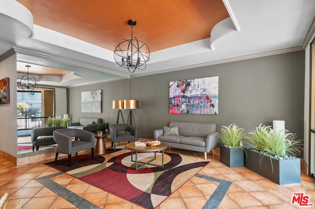 interior space with an inviting chandelier, a tray ceiling, and ornamental molding