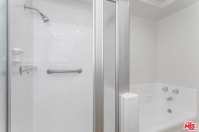 bathroom featuring separate shower and tub