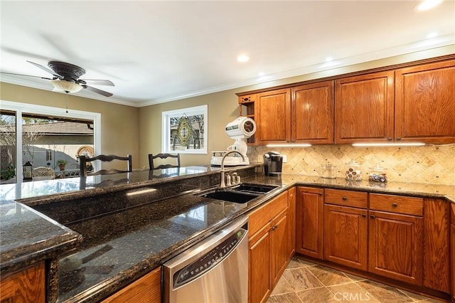 kitchen with sink, crown molding, dishwasher, decorative backsplash, and dark stone counters