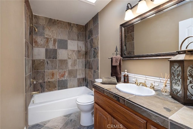 full bathroom with vanity, toilet, and tiled shower / bath