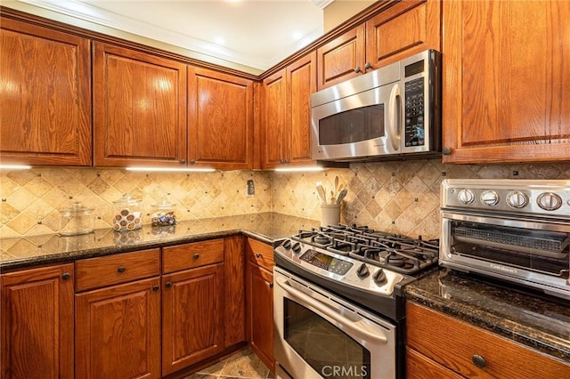 kitchen featuring backsplash, stainless steel appliances, and dark stone countertops