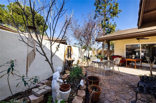 view of patio featuring ceiling fan