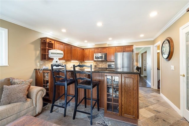 kitchen featuring a kitchen bar, tasteful backsplash, crown molding, appliances with stainless steel finishes, and kitchen peninsula